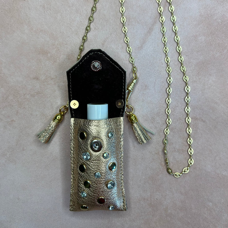 Interior of gold leather pouch necklace with crystal. Suede lining. For lipstick or lip balm.