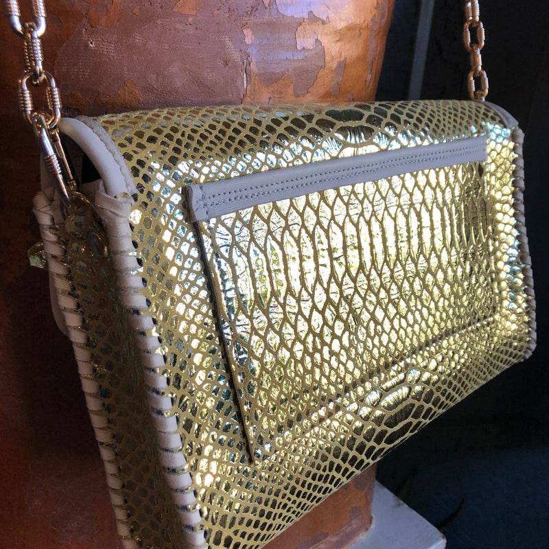 Back view of gold snake print leather clutch