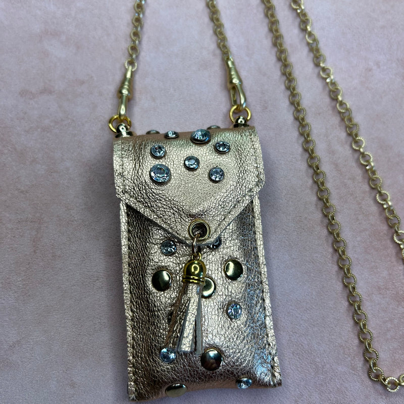 Close up of gold leather pouch necklace with crystals & gold nailheads.