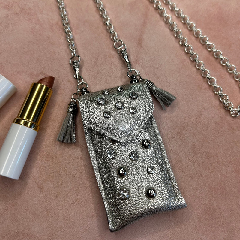 Close up of crystal accents on silver leather pouch necklace on long silver chain for your lipstick.