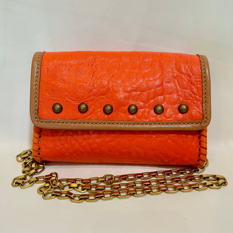 Orange croc leather mini bag with light tan trim, domed studs, shown with brass chain handle.