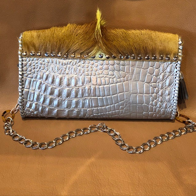Back view of metallic silver leather clutch with springbok & nailhead accents.