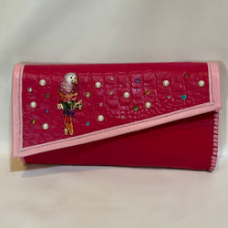 Colorful crystal embellished magenta pink leather clutch.