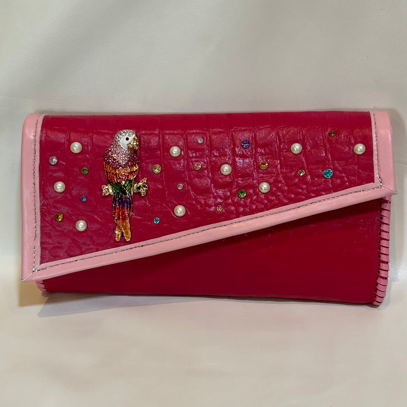 Colorful crystal embellished magenta pink leather clutch.