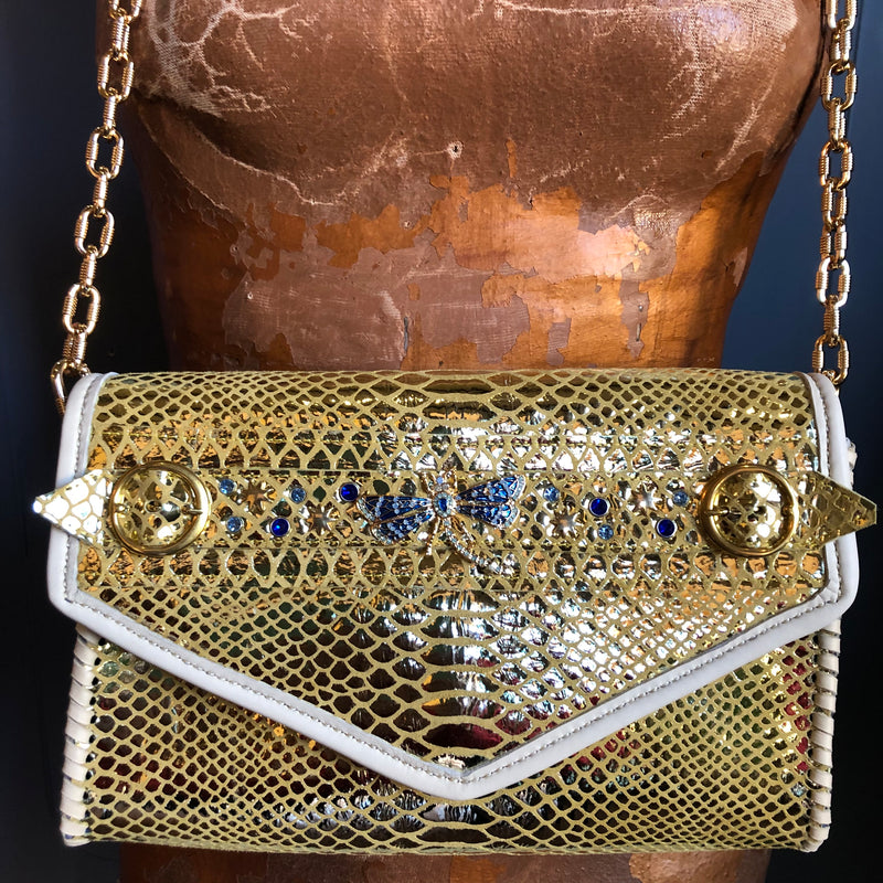 Gold snake print leather clutch embellished with blue crystals and a chunky chain handle
