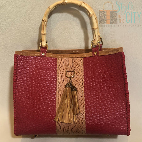 Red and Tan leather tote bag with bamboo handles and tassels.