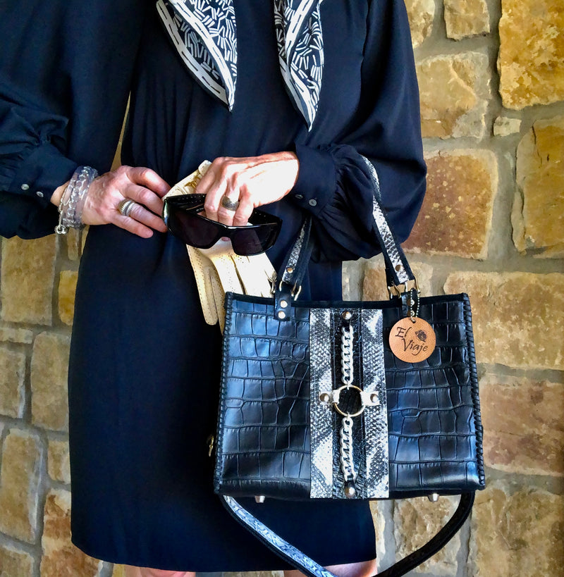Style view of black croc print leather tote bag with dressy black outfit