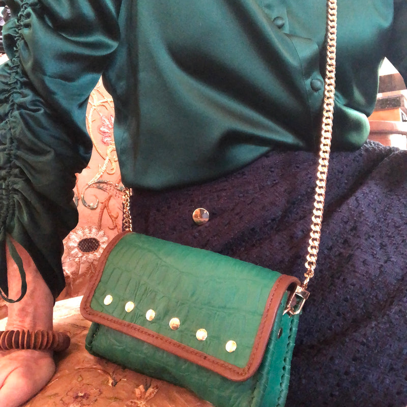 Styled view of Emerald Green Croc Leather mini bag on long gold chain.