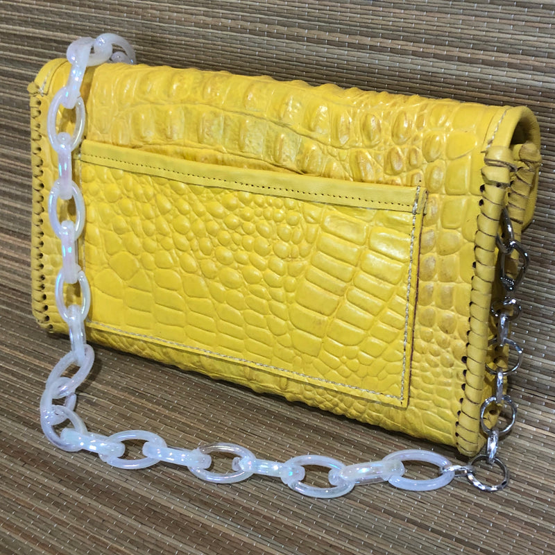 Back view of open pocket on yellow croc print leather clutch with multicolored crystals