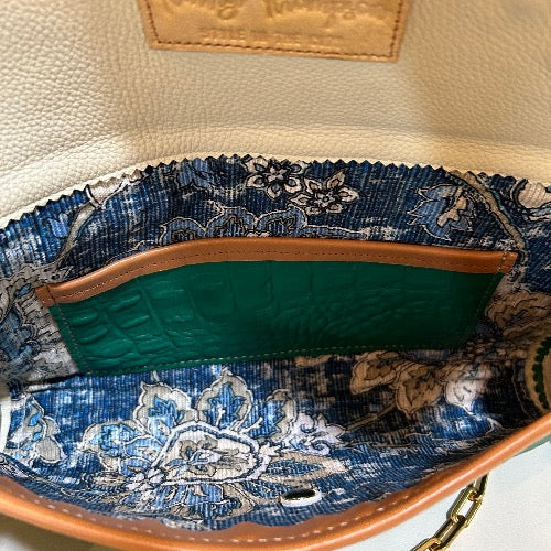 Interior indigo fabric and leather lining of embellished green croc print leather bag with tan trim