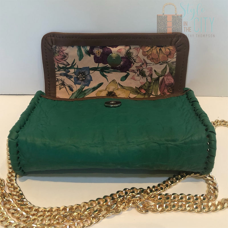 Interior view of green croc leather mini bag with floral printed leather lining.