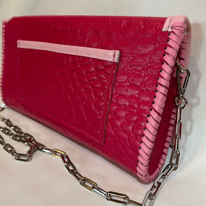 Back view of magenta pink leather clutch. 