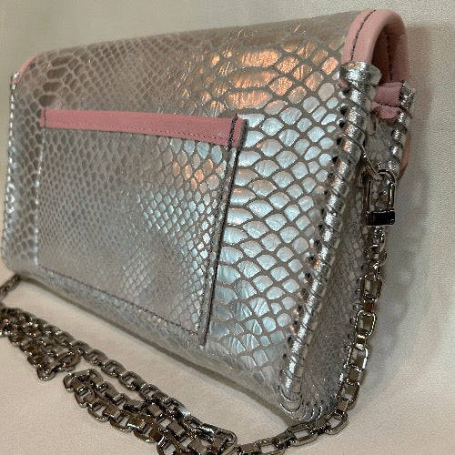Back view of silver snake print leather clutch with open pocket for phone. 