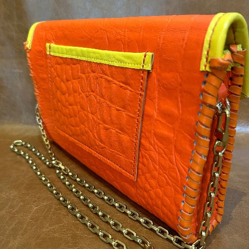 Back view of orange croc print leather clutch with gold chain