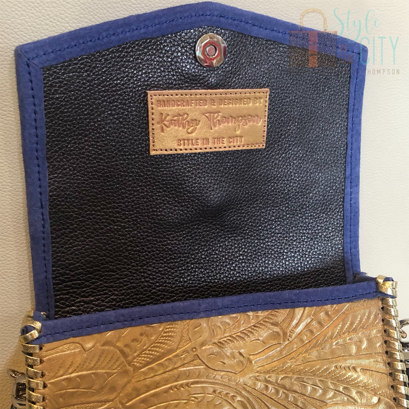 Close up view of interior of Metallic Gold leather crossbody bag with boho strap