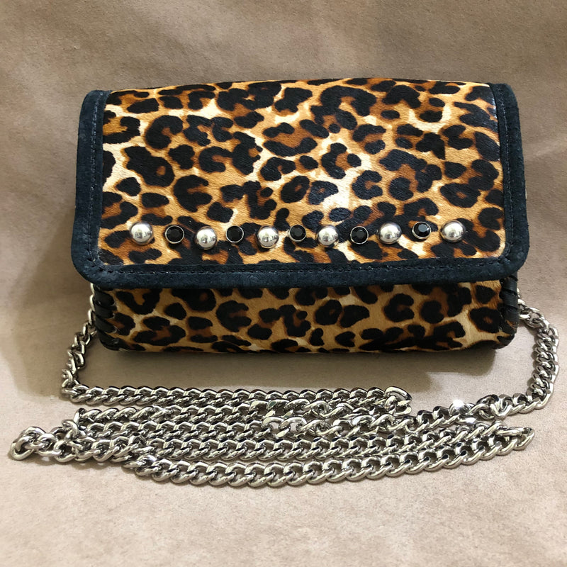 Leopard print leather mini bag on long silver chain with silver stud accents.