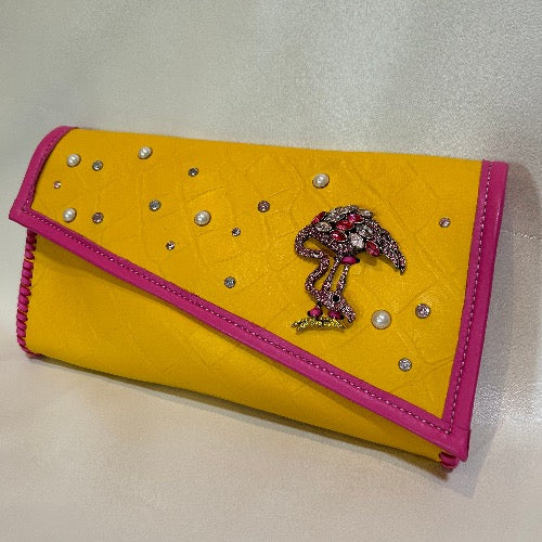 Yellow croc print leather bejeweled clutch bag with pink flamingo.