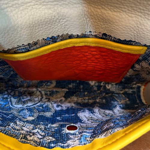 Interior indigo fabric & cream leather lining of orange croc print leather clutch