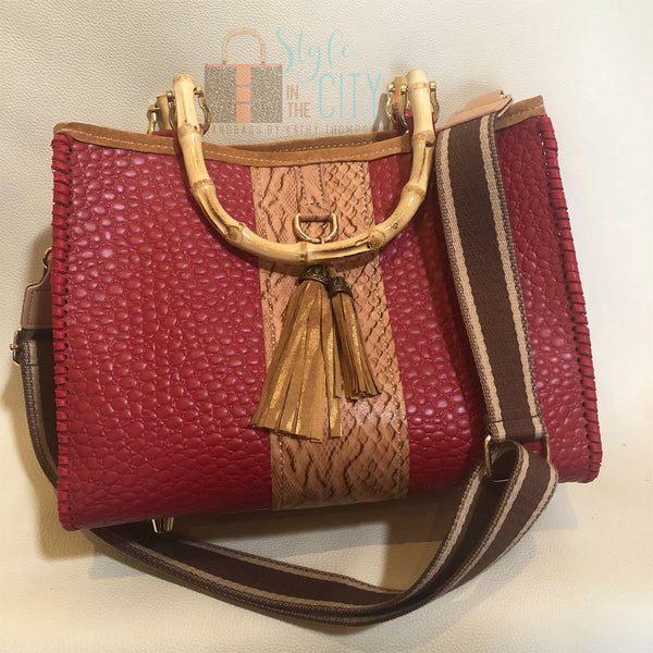 Red and Tan leather tote purse with bamboo handles & tassels and a webbing shoulder strap.