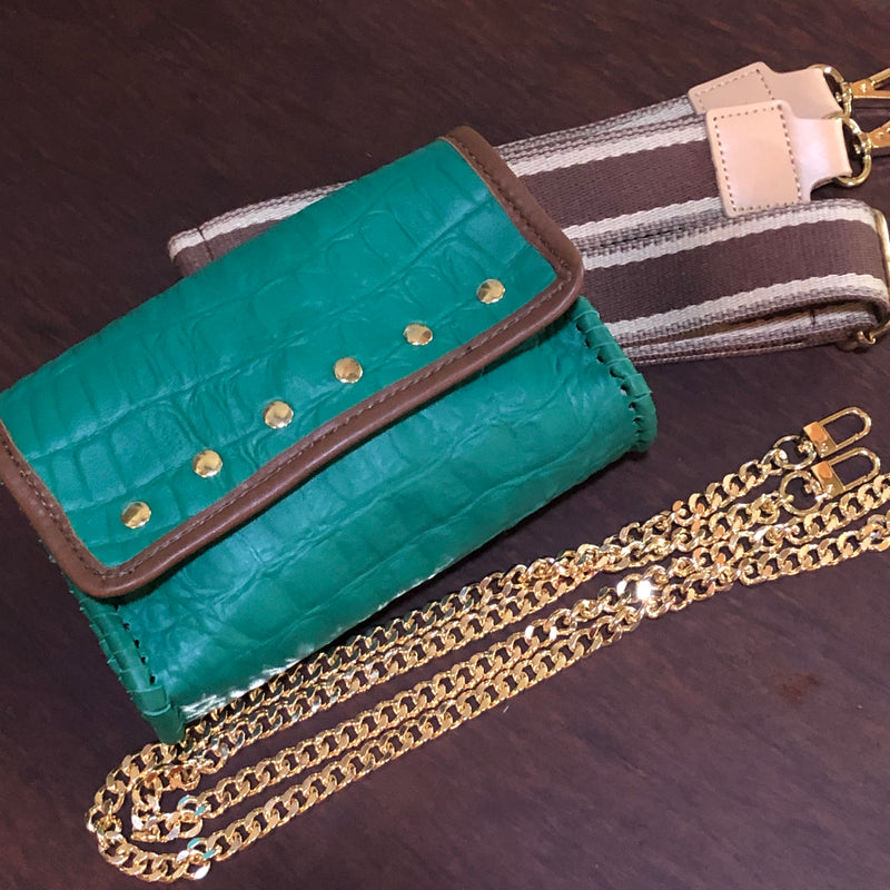 Emerald “jewel tone” embossed leather with chocolatey Brown leather trim, Gold nailheads, 2 very cool straps, and a stunning floral interior! So posh!