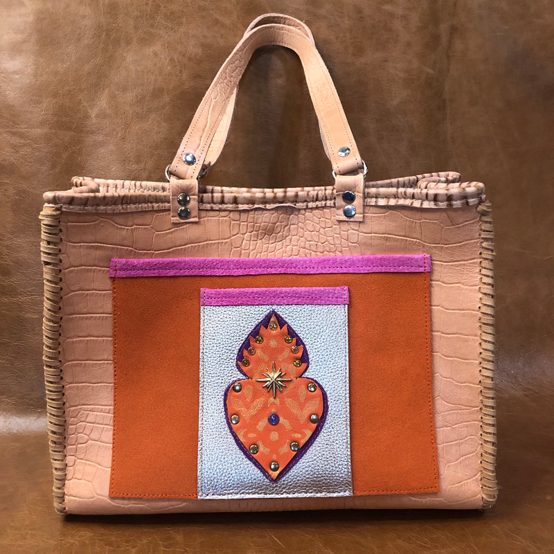 Tan croc print leather tote bag with flaming heart motif. 