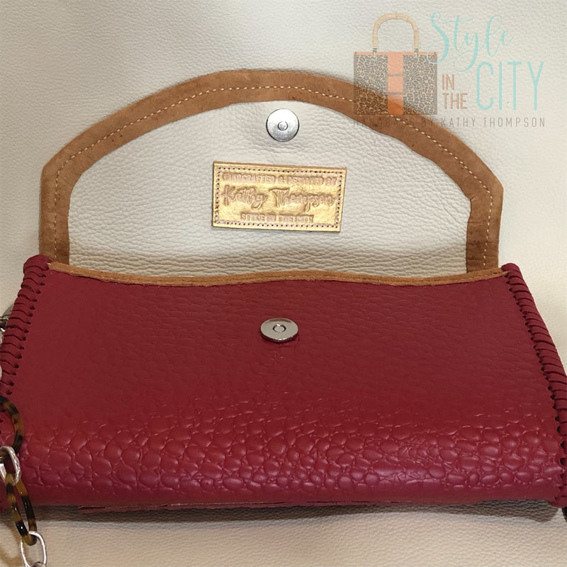 Inside view of red leather handbag with leopard trim.
